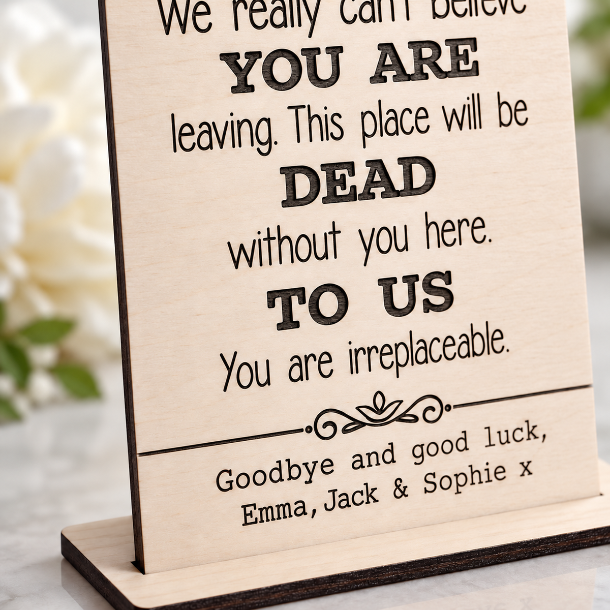 Close-up of the engraved farewell message and personalised names on birch plywood