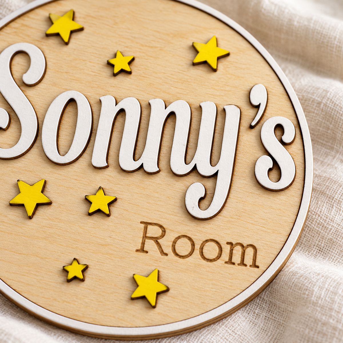 Close view of the birch wood bedroom plaque, raised name lettering, white border and engraved wording