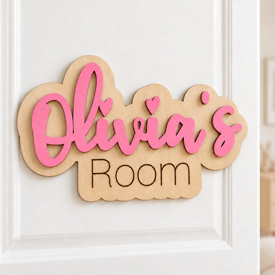 Pink Olivia's Room personalised wooden bedroom door sign with raised lettering and a natural birch backing on a white door