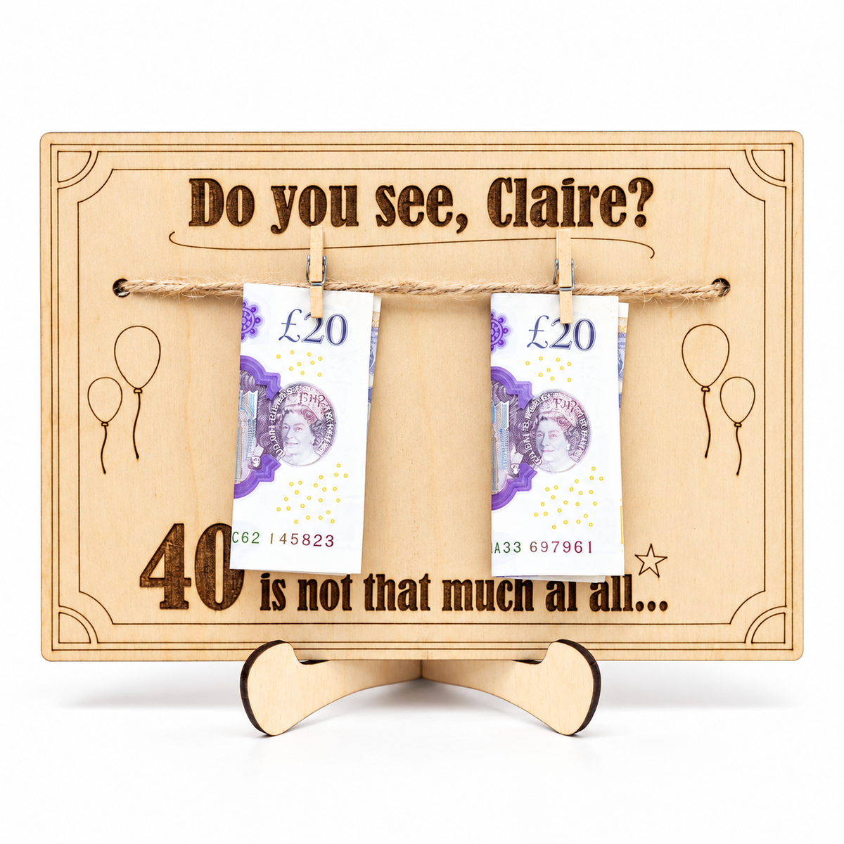 Front view of a wooden birthday money holder engraved with a custom name and age, shown with cash for illustration