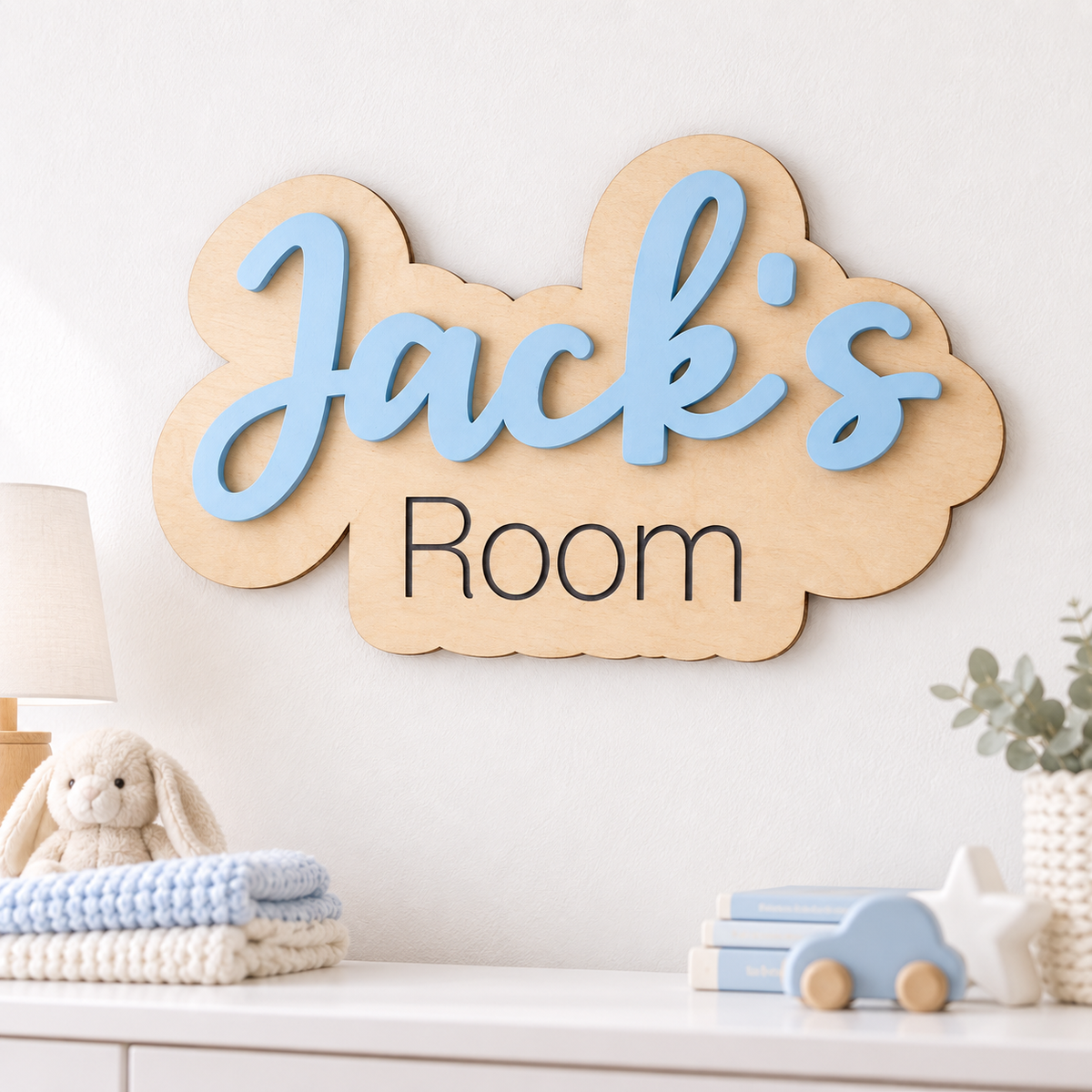 Pastel blue Jack's Room wooden name sign mounted above a dresser in a bright child's bedroom