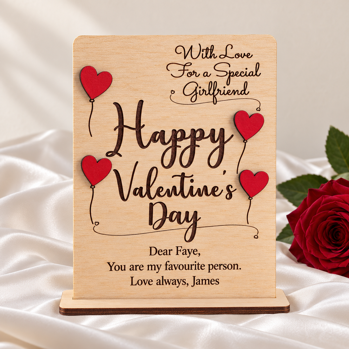 Front view of personalised wooden Valentine's card with engraved message and four raised red heart balloons