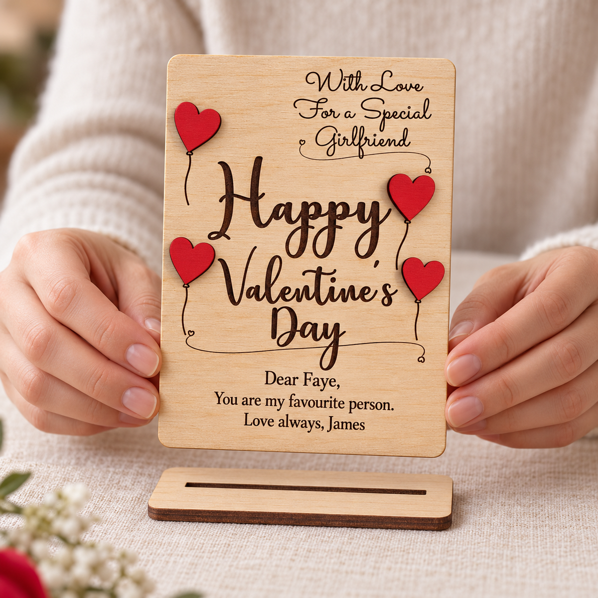 Wooden Valentine's keepsake card held in hands with its separate slotted display stand