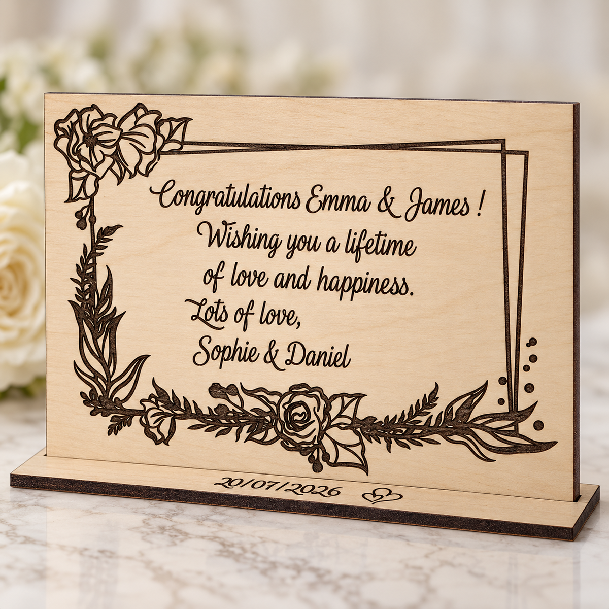 Close view of dark laser engraved wedding message and botanical floral border on natural birch wood