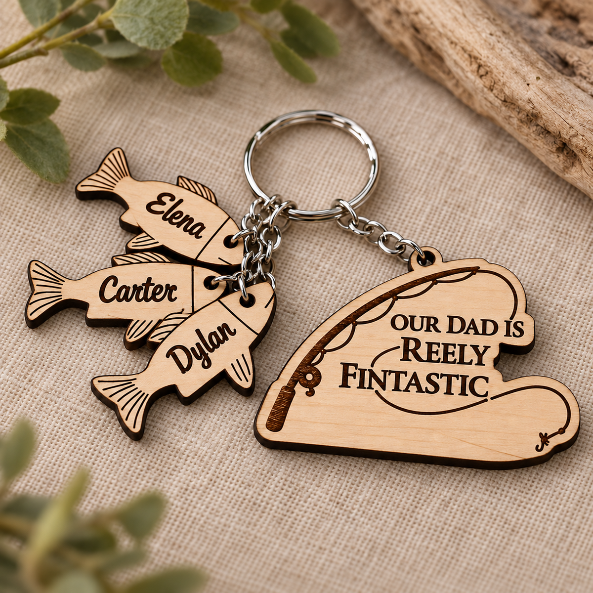 Close-up of the dark Reely Fintastic engraving, fishing rod design and named wooden fish charms