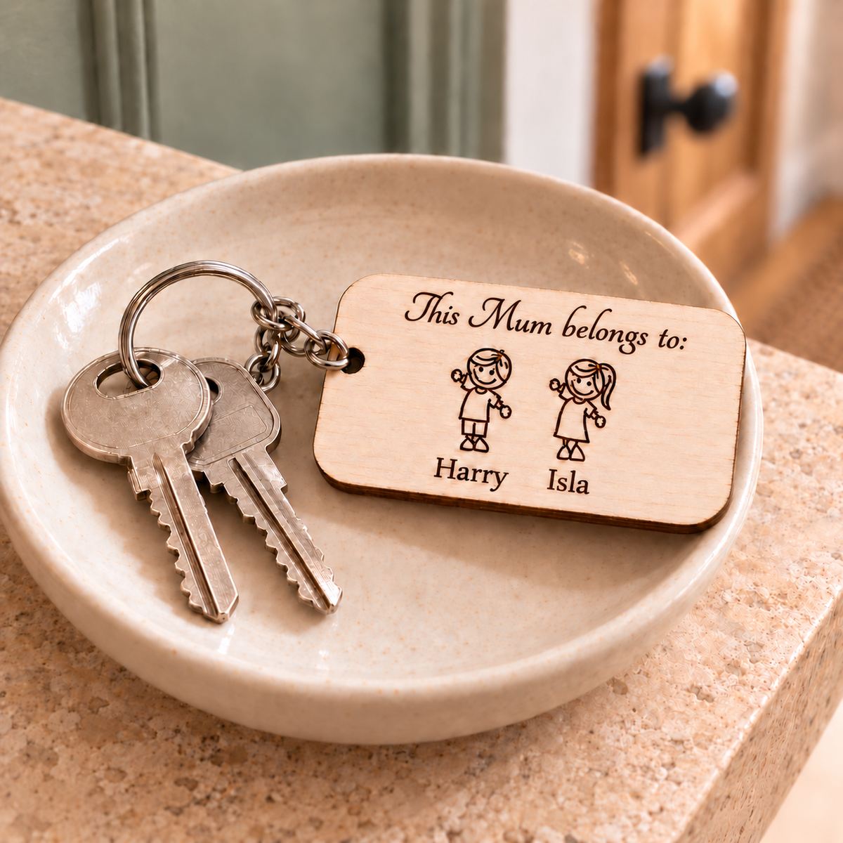 This Mum Belongs To wooden keyring engraved with Harry and Isla beside house keys