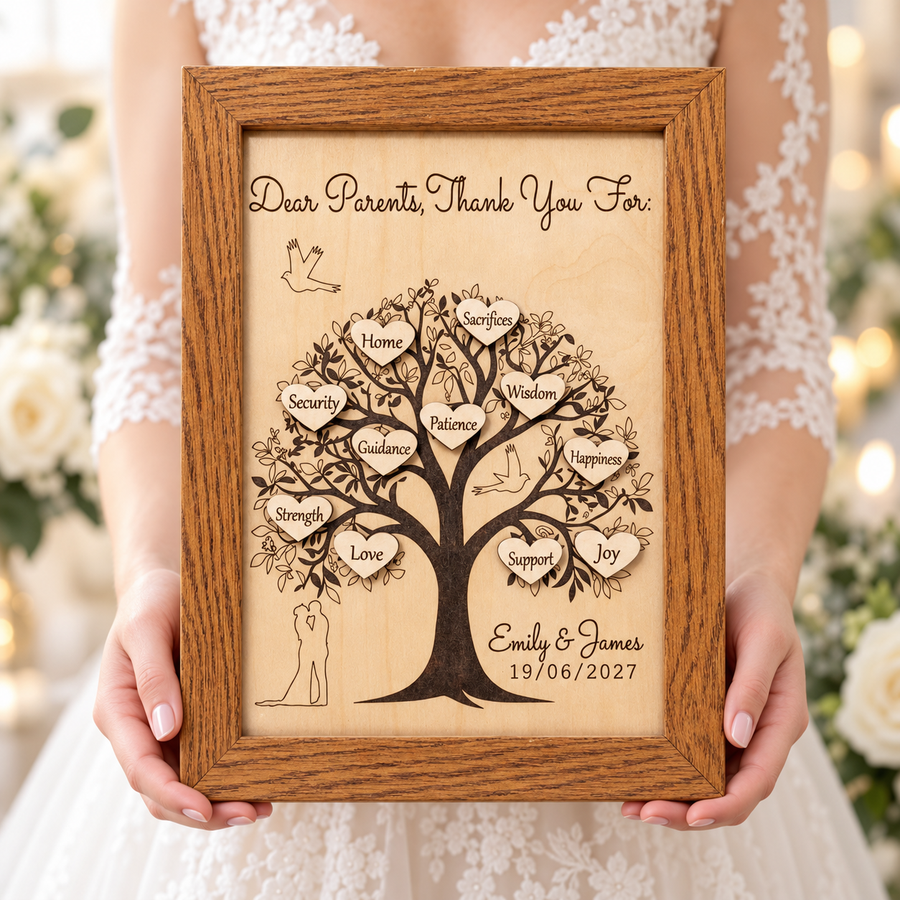 Personalised wedding thank you gift for parents, an engraved wooden tree in an oak-style frame held by a bride.