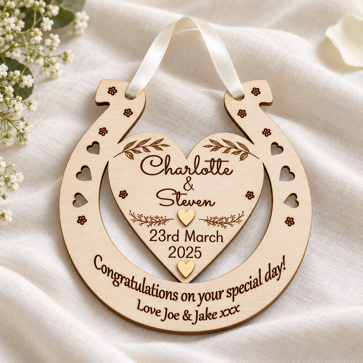 Natural wood grain, dark engraved message and ivory satin ribbon on a personalised wedding horseshoe