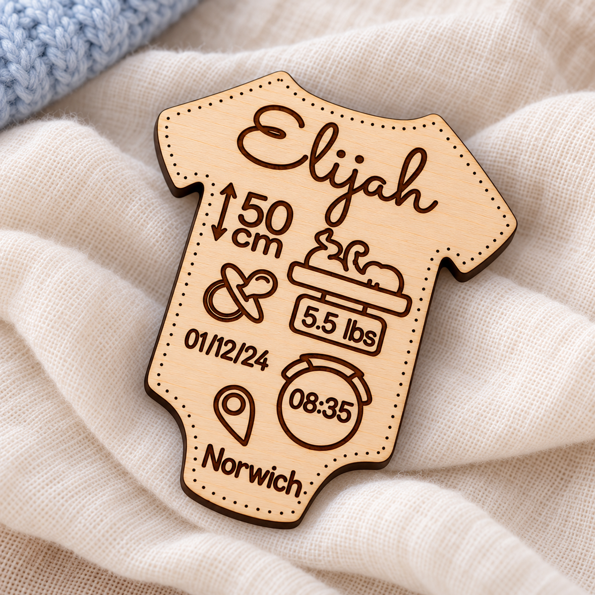 Engraving detail on a wooden baby vest birth stats magnet
