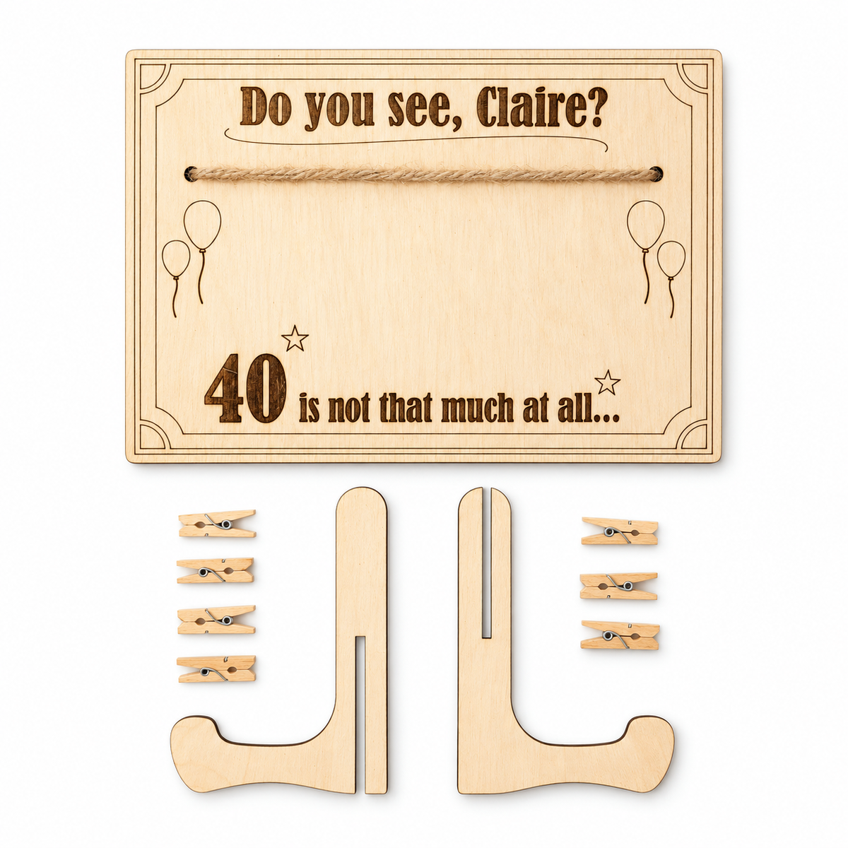 Birthday money holder kit laid flat, showing the engraved wooden plaque with twine, two stand pieces and seven miniature pegs