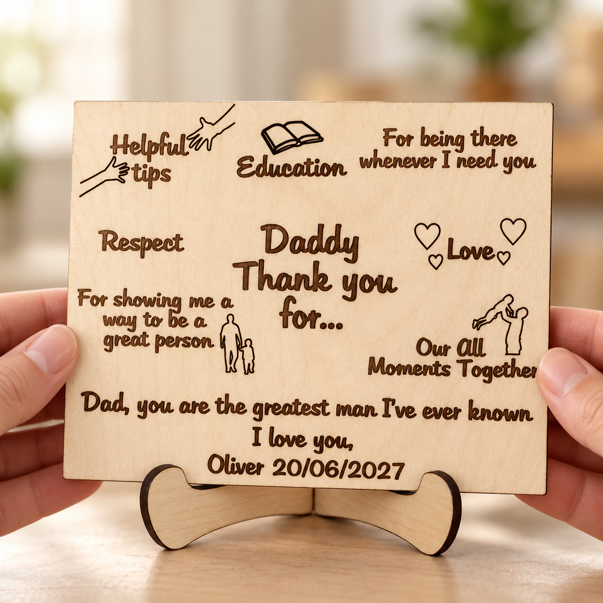 Wooden Father's Day card held in hands, showing personalised engraved text and curved wooden stand