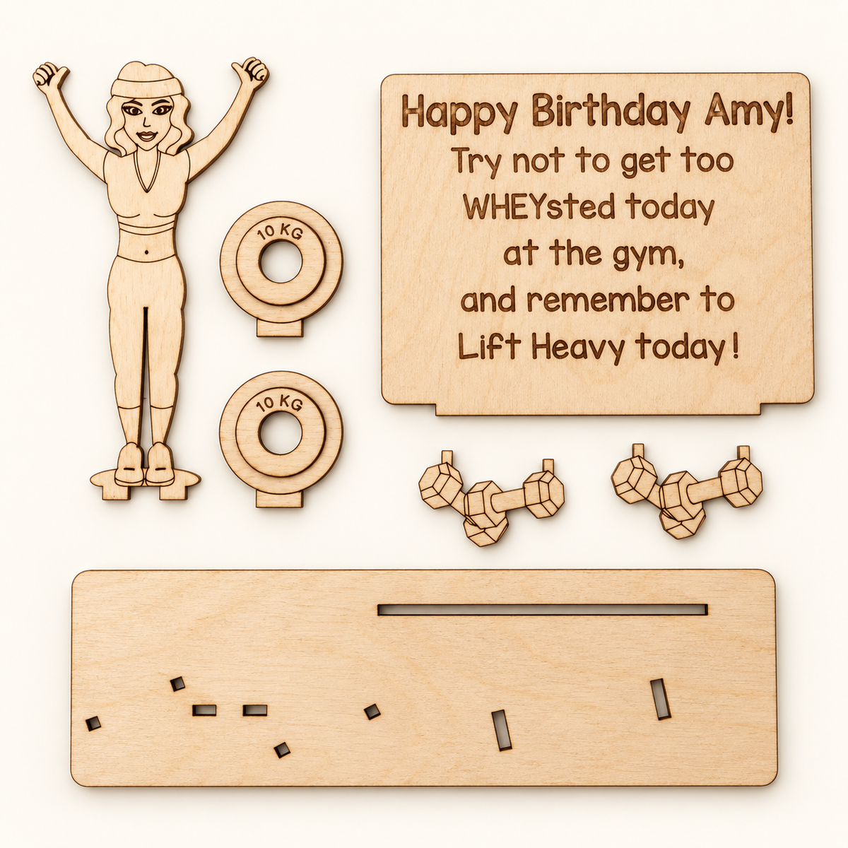 Seven wooden parts of the gym money holder laid flat, including the slotted base, gym figure, plaque, dumbbells and weight plates