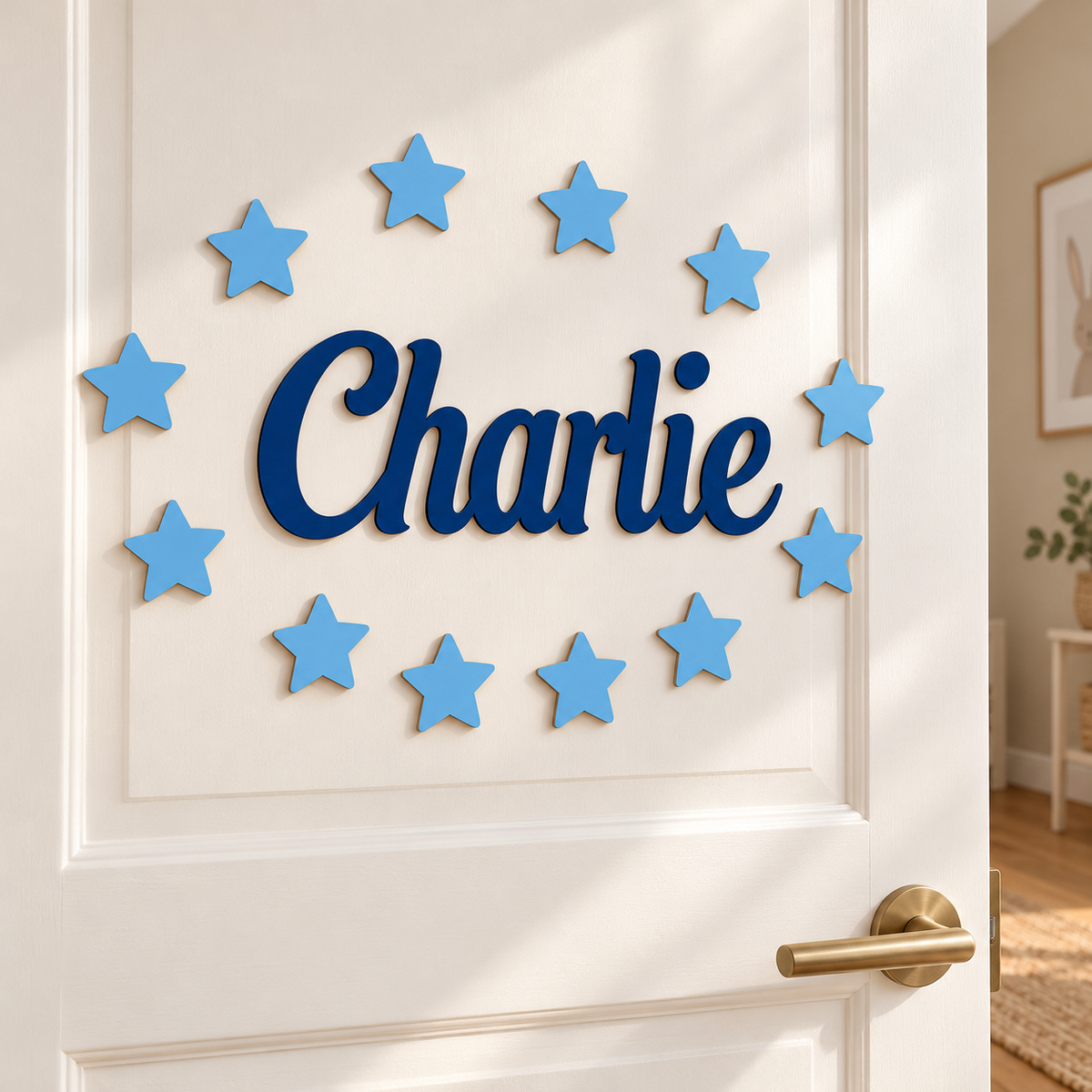 Navy blue wooden name Charlie with twelve equal pastel blue stars mounted on a white bedroom door