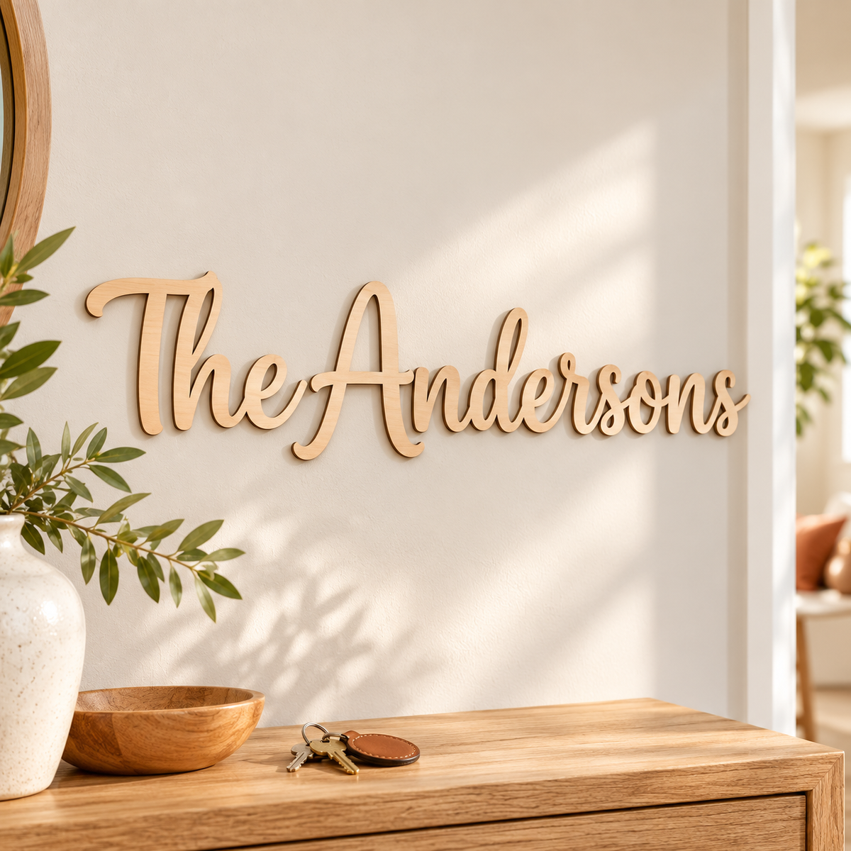 The Andersons wooden surname wall sign in Unpainted natural birch, displayed in a neutral hallway