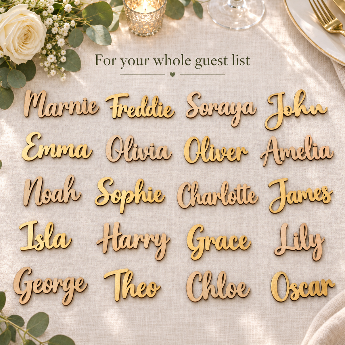 Twenty personalised wooden guest names in Gold and Unpainted finishes arranged on ivory wedding linen